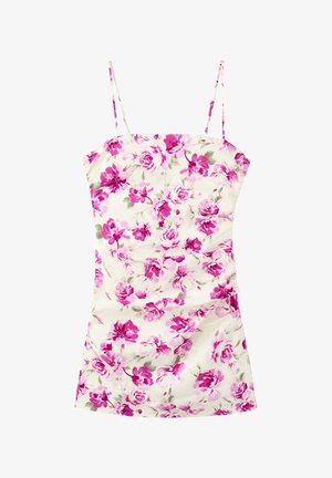 Robe courte sans manches avec fines bretelles, fond blanc et motif floral rose vif avec des feuilles vertes.