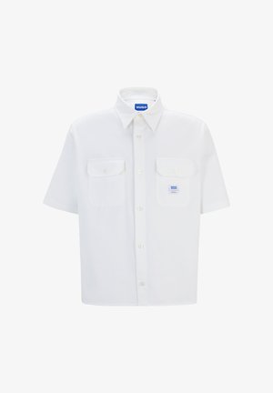 Camisa blanca de manga corta con cuello abotonado, dos bolsillos frontales y una etiqueta de logo azul. Fabricada en un tejido suave con un ajuste entallado.