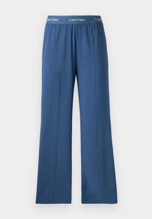 Navyblauwe wijde broek met een elastische tailleband en een contrasterend merkembleem. Gemaakt van een gladde, lichte stof.