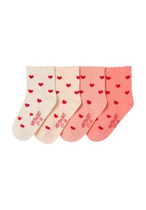 Four pairs of children's socks in gradient beige to pink shades, each with red heart patterns and size text "VERTRAUDET 27-30" on the sole.