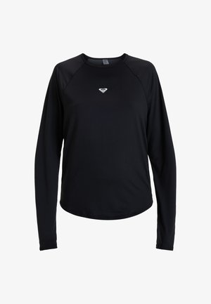 Čierne tričko s dlhým rukávom a okrúhlym výstrihom s malým bielym logom v tvare srdca umiestneným v strede hrudníka, zobrazené na bielom pozadí.