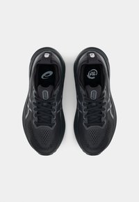 Black athletic shoes with a breathable mesh upper, textured surface, and reflective accents. Laces and padded collar for comfort.