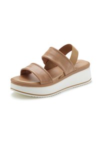 Tan leather platform sandals with two wide straps and a white rubber sole. The design features contrasting stitching along the straps.