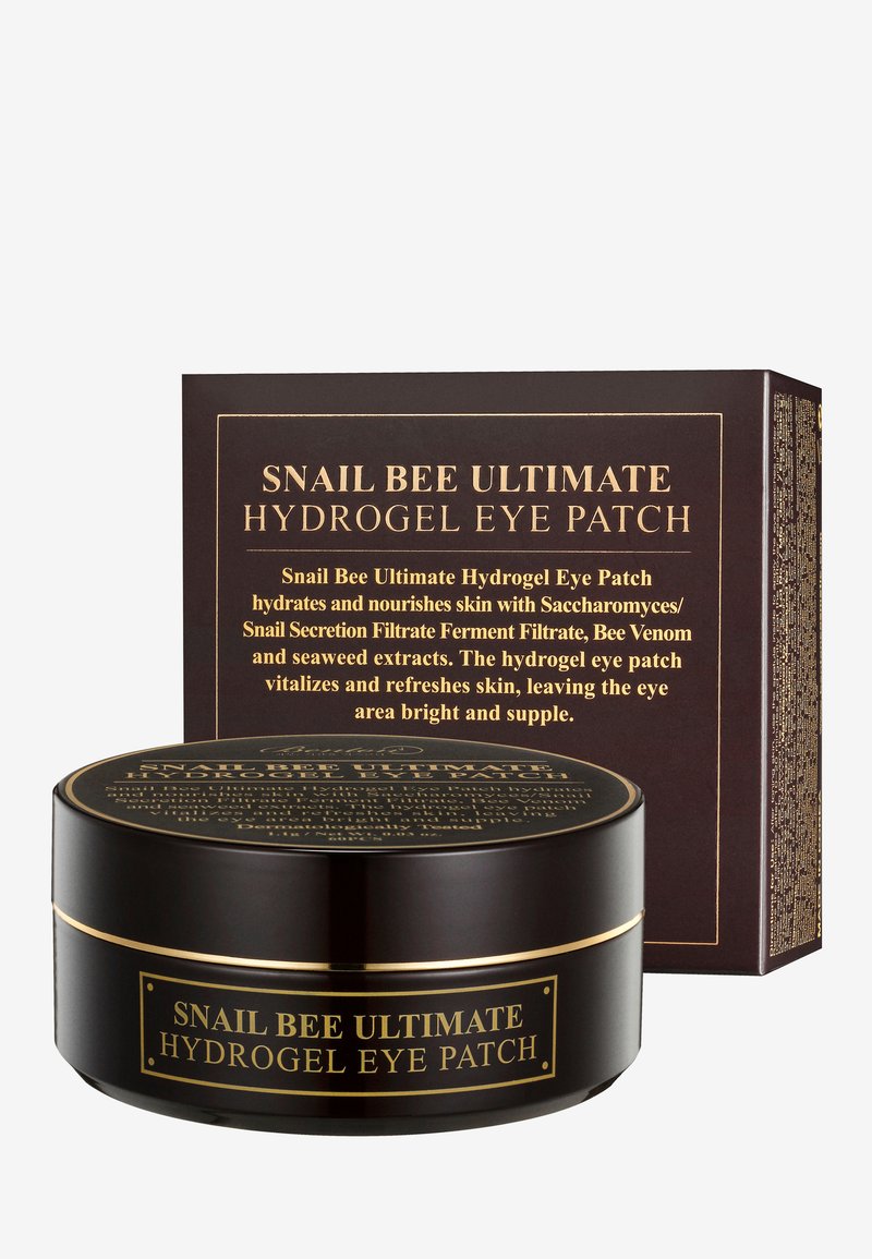 Contenant rond noir avec des accents dorés, étiqueté "Patch Hydrogel Ultime Snail Bee pour les Yeux." Accompagné d'une boîte de produit assortie avec texte détaillé.