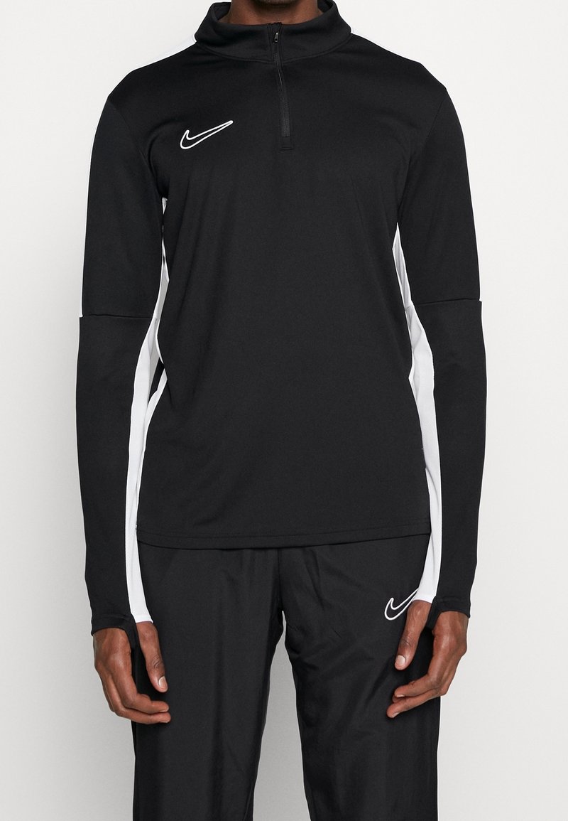 Black athletic long-sleeve shirt with a quarter-zip, white side stripes, and a small white Nike logo on the chest. Textured, moisture-wicking fabric.