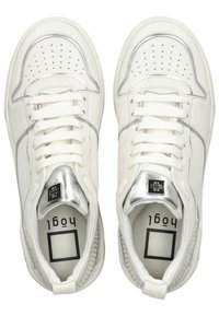 White sneakers with a smooth leather upper, silver accents, perforated toe area, and a textured heel detail. Laces and padded tongue included.