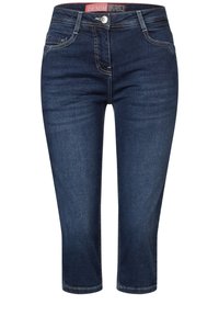 Tummansiniset capri-farkut, jotka on valmistettu denimistä. Niissä on klassinen viiden taskun muotoilu, vetoketjullinen etumalli ja kontrastiväriset saumat.