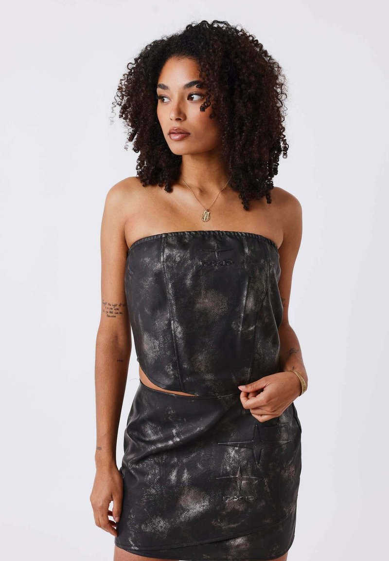 Black leather two-piece outfit featuring a strapless top and a fitted mini skirt, with a textured surface and metallic accents.