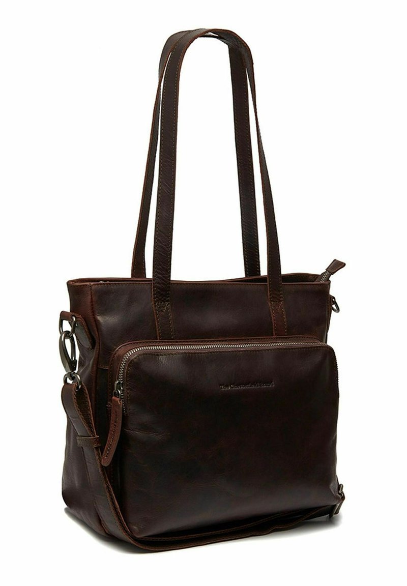 Bruine lederen schoudertas met twee lange handvaten. Voorzien van een ritsvak aan de voorkant en contrasterende stiksel. Harde textuur met een ingetogen ontwerp.