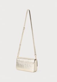 Malá metalická zlatá kožená crossbody taška s dlhým nastaviteľným pásom a klopou, zobrazená na jednoduchom bielom pozadí.