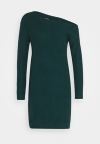 Abito in maglia strutturata verde scuro, con scollatura asimmetrica e maniche lunghe. Dettagli a coste sui polsini e sull'orlo.