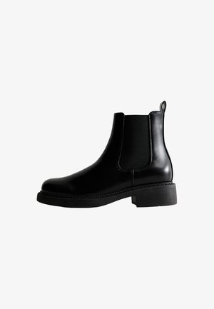 Schwarze Lederstiefeletten mit elastischen Seitenpanels, runder Zehenpartie, niedrigem Blockabsatz und einer gestickten Kante an der Sohle.