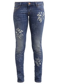 Kapeita farkut, jotka on valmistettu sinisestä denimmateriaalista, jossa on vaaleansinisiä kukkakuvioita etupuolella, viisi taskua ja nappisuljenta.