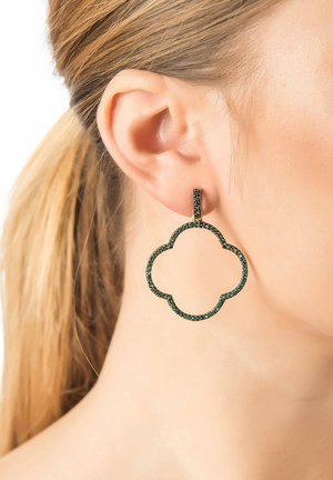Green gemstone hoop earring with a floral outline design. Gold-tone hardware accents with a smooth, polished texture.