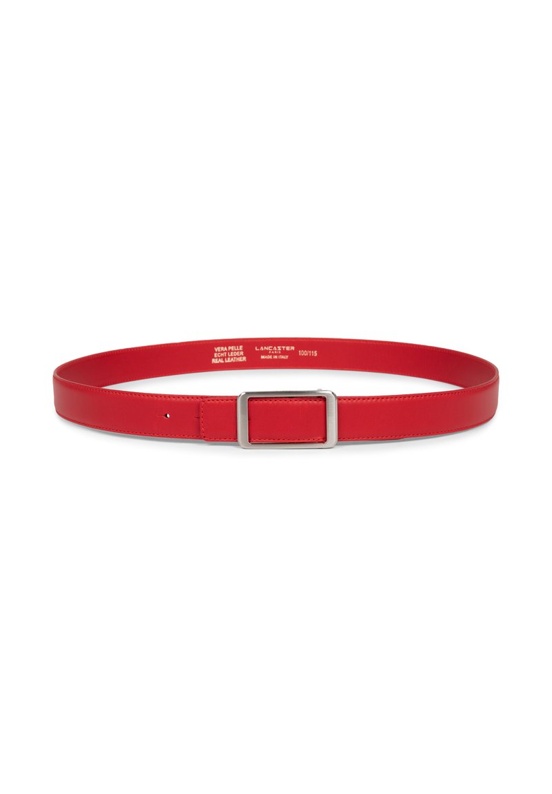 Ceinture en cuir rouge avec une boucle rectangulaire en argent, non attachée, posée à plat sur un fond blanc, marquages de taille visibles à l'intérieur.