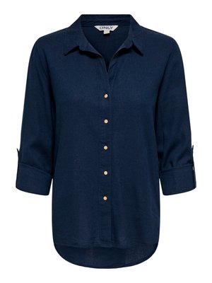 Navy blue long-sleeve button-up shirt with collar, seven beige buttons, and rolled cuffs. Hem is slightly curved and longer in back.