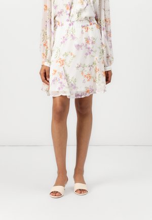 Floral dress with a white background, featuring orange, purple, and green flowers. Elastic waistband, soft fabric, knee-length, ruffled hem.