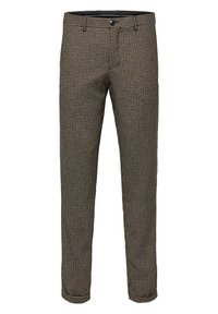 Beige- och bruna houndstooth-mönstrade byxor med smal passform, med knappstängning och bälteshällor, tillverkade av ett texturerat tyg.