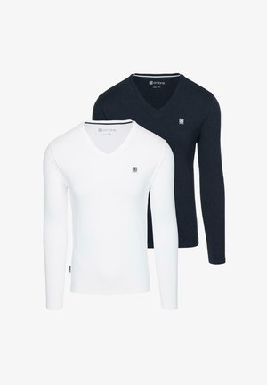 Two long-sleeve v-neck t-shirts, one white and one navy blue, made from a solid fabric featuring a small logo on the chest.