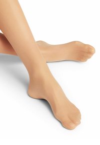 Collants beiges transparents avec une texture lisse et une finition douce, couvrant les jambes et les pieds. Design à orteils ouverts notable pour la respirabilité.