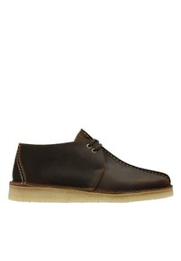 Brown leather shoe with a round toe and two eyelets. Features contrast stitching and a light-colored rubber sole. Smooth texture, no patterns.