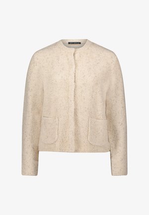 Veste beige texturée avec encolure ronde, patte de boutonnage à l'avant et deux poches plaquées. Tissu doux avec un léger éclat, idéal pour superposer.