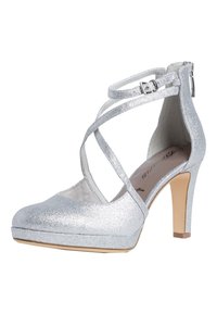 Srebrne błyszczące szpilki z zamkniętym noskiem, krzyżującymi się paskami i zamkiem błyskawicznym z boku. Wysokość obcasa wynosi około 10 cm.