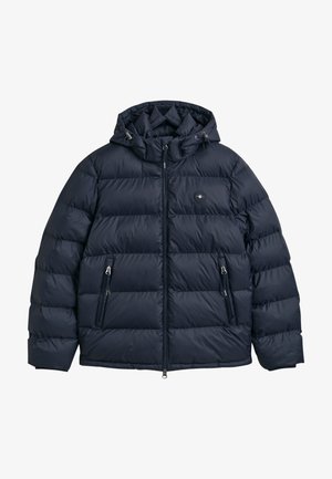 Donkerblauwe pufferjack met capuchon, met een quilted ontwerp, twee zijzakken met ritssluiting en een logo-opdruk op de borst.