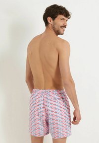 Farbige Stretch-Badehosen mit einem pinken Hintergrund und Mustern von blauen und roten Autos. Elastischer Bund und lockere Passform für mehr Komfort.