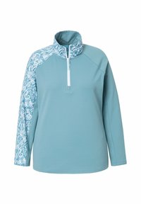 Pullover azzurro chiaro con zip a un quarto, caratterizzato da un motivo bianco su una manica. Realizzato in un tessuto morbido ed elastico.