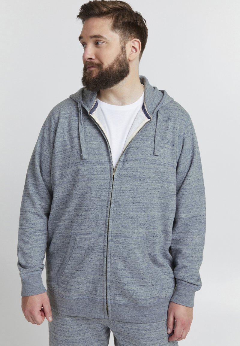 Hettegenser med glidelås i heathered blågrått stoff. Har to frontlommer og snor i hetta. Myk tekstur, uformell design.
