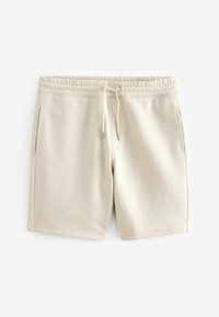 Shorts beiges en tissu doux, avec une taille élastique, un cordon de serrage et des poches latérales. Texture lisse avec une coupe décontractée.