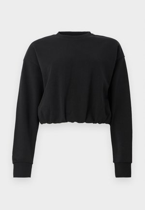 Black cropped sweatshirt made of soft fabric. Features long sleeves, a round neckline, and a gathered hem for a relaxed fit. Simple design.
