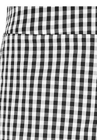 Black and white checkered fabric with small squares, smooth texture, suitable for clothing, showcasing a consistent pattern.
