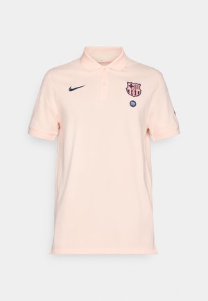 Camisa polo de Nike en rosa claro con el escudo del FC Barcelona y el logo de Spotify en el frente, mangas cortas y cuello abotonado.