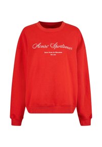 Červená mikina s dlhými rukávmi, okrúhlym výstrihom a rebrovanými manžetami a spodným lemom. Obsahuje biely nápis: "Aim'n Sportswear" a "Každodenná dávka wellness."