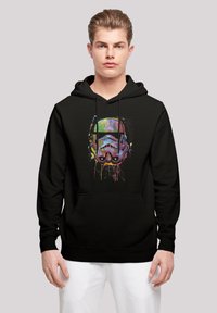 Svart hoodie med en färgglad, stiliserad stormtrooperhjälm som grafisk design, justerbara snören och en framficka.