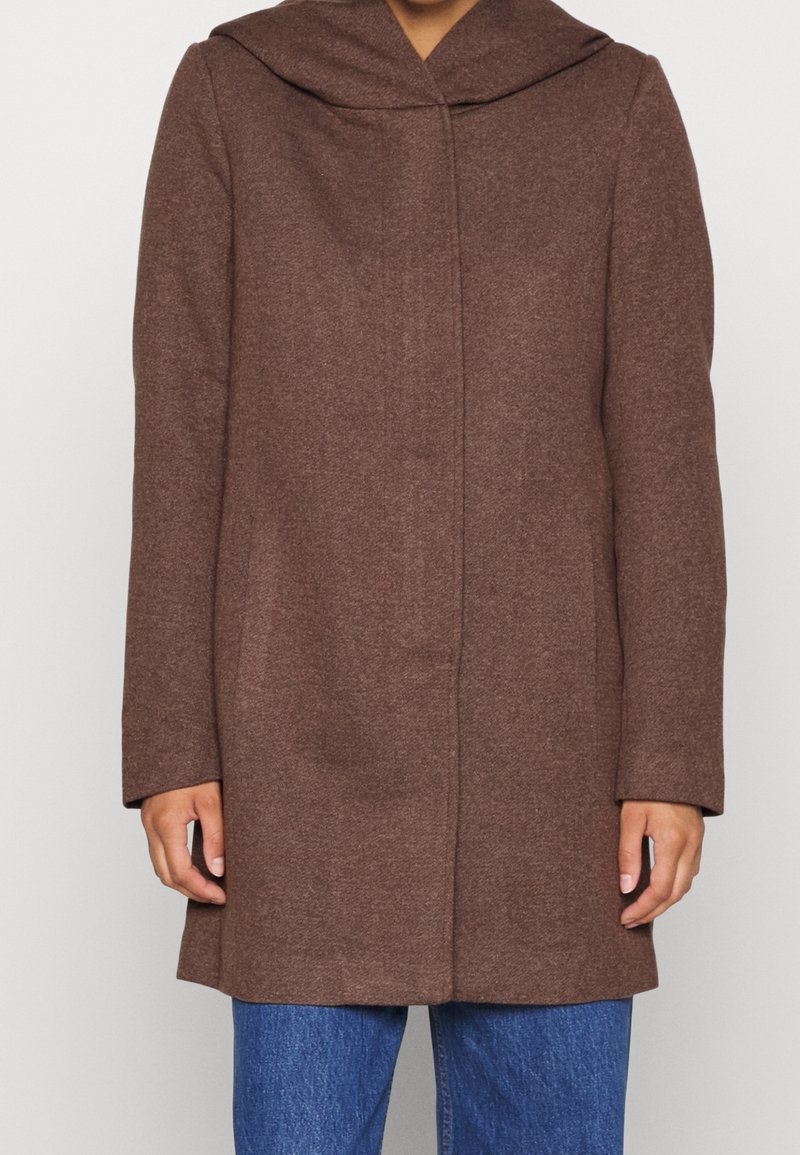Brown wool coat with a large hood, straight cut, and long sleeves. Features a buttonless front and side pockets.