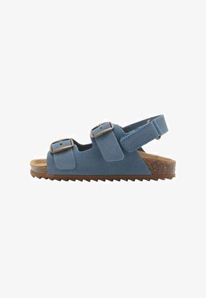 Sandales en suede bleu avec deux brides à boucle ajustables, semelle en liège marron et semelle en caoutchouc texturé présentant un motif en zigzag.