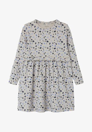 Langærmet beige kjole med i taljen, pyntet med små blå og sorte blomsterprint over det hele.