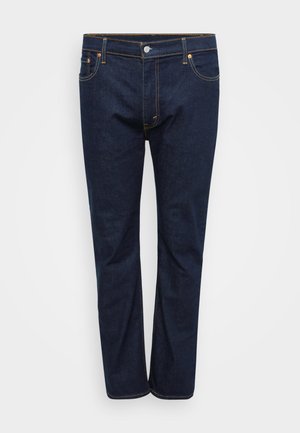 Donkerblauwe denim jeans met een rechte pijpdesign, voorzien van zichtbare stiksels in contrasterend geel, vijf zakken en een knoopsluiting aan de voorkant.
