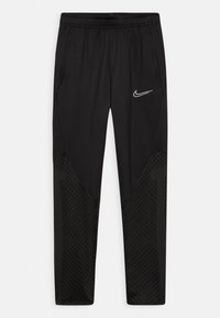 Pantalons de sport noirs avec une finition lisse, dotés d'une taille élastique, de poches latérales et d'un motif texturé noir sur le bas des jambes.