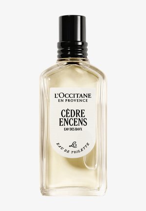 Clear glass perfume bottle with black cap labeled L'Occitane en Provence Cèdre Encens Eau de Toilette.