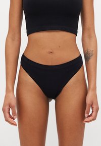 Black ribbed fabric high-waisted bikini briefs with a soft waistband and smooth finish, designed for comfort and modest coverage.