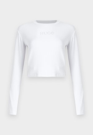 White long-sleeve cropped top made of smooth fabric, featuring a subtle "HUGO" logo in light gray on the front.