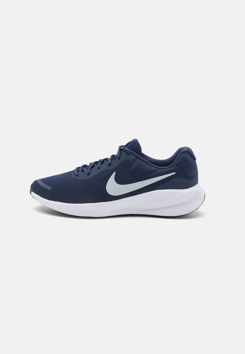 Chaussure de course Nike bleu marine avec logo Swoosh blanc et semelle épaisse blanche, présentée de profil sur un fond uni.