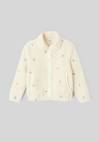 Veste en polaire couleur crème avec col, fermeture à boutons, broderie florale et deux poches latérales. Texture douce.
