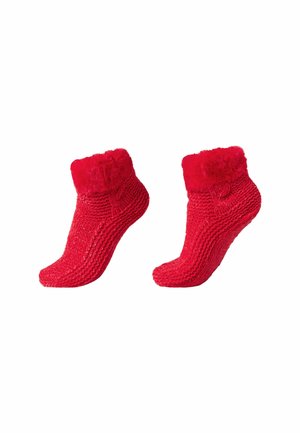 Rote gestrickte Socken mit einem dicken, flauschigen Bündchen. Die Oberfläche ist gerippt und weich, mit einer engen Passform um den Knöchel.