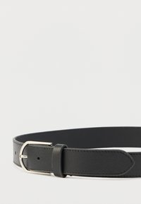 Sort læderbælte med en tekstureret finish og spænde i sølvmetal. Glatte kanter og pæn syning langs hele bælte.