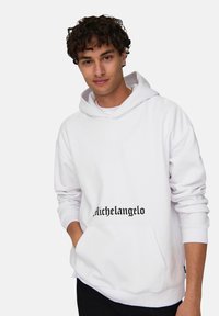 Sudadera blanca con bolsillo frontal, capucha con cordón ajustable y diseño de texto negro "Michelangelo" en el frente. Textura de tela suave.